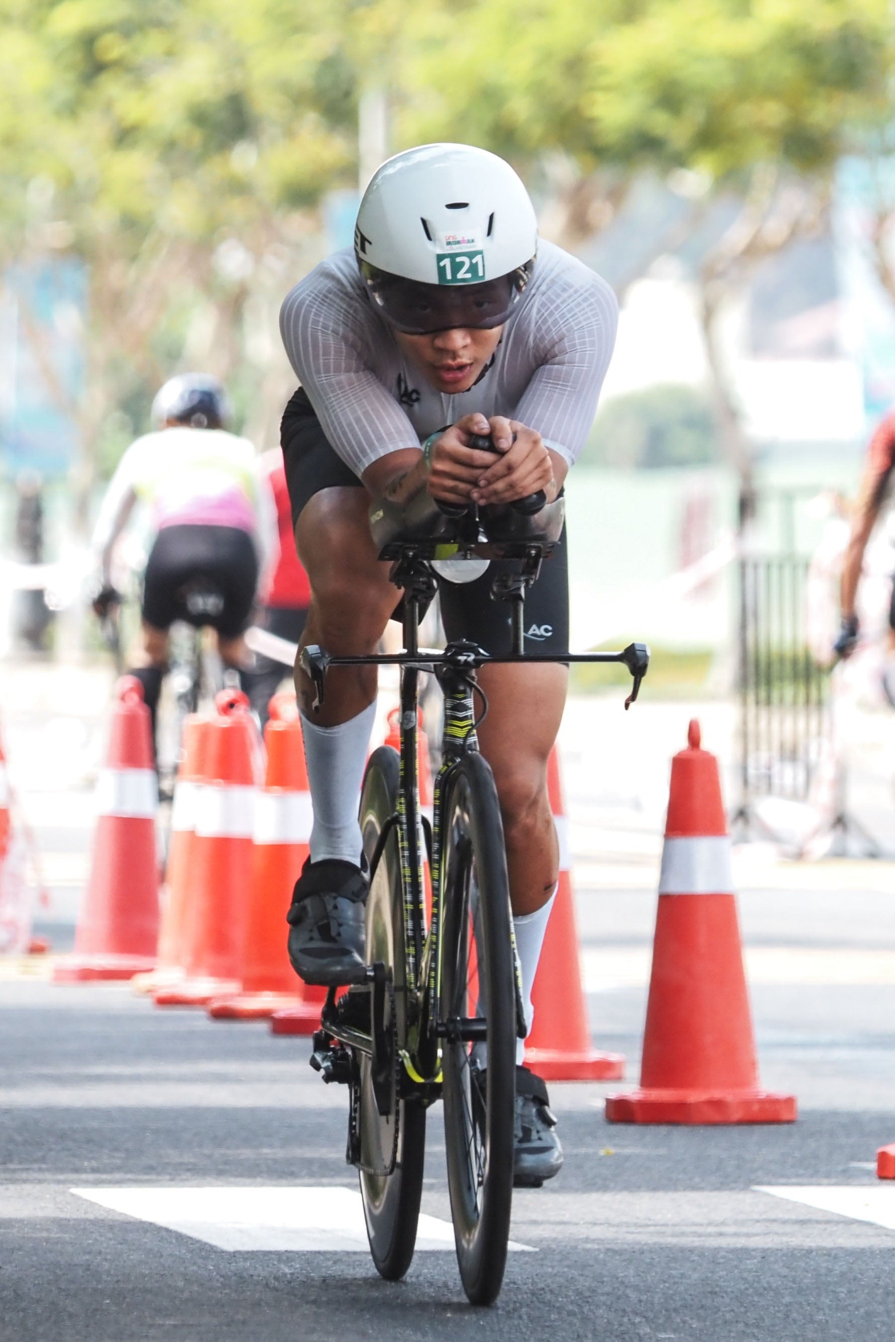 Cyclist in a race with traffic cones on a road