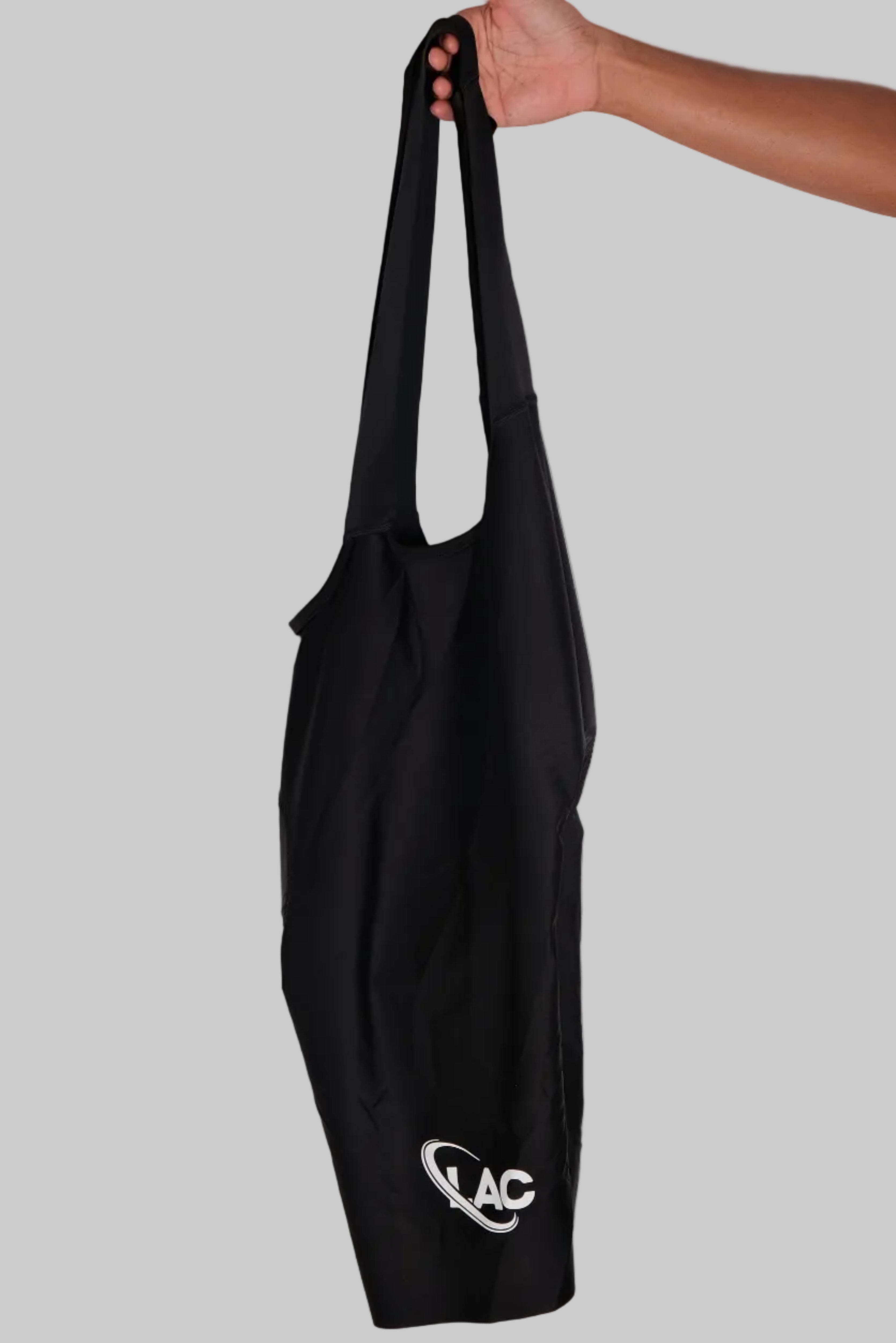 Black tote bag with a logo on a light gray background