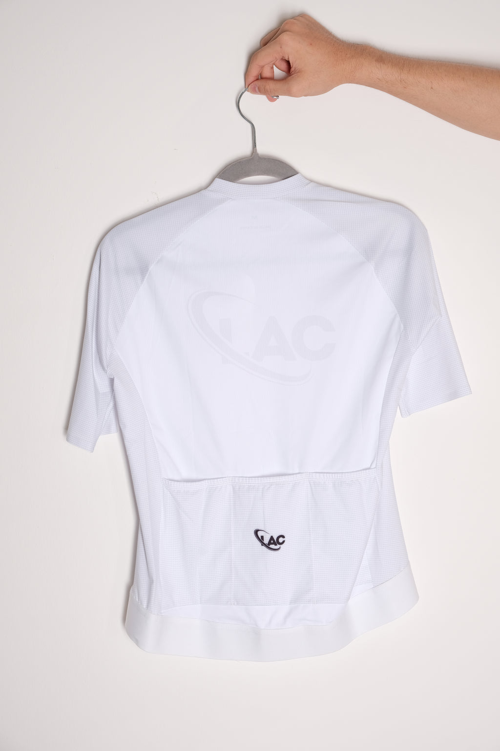 White cycling top with a logo on a white background