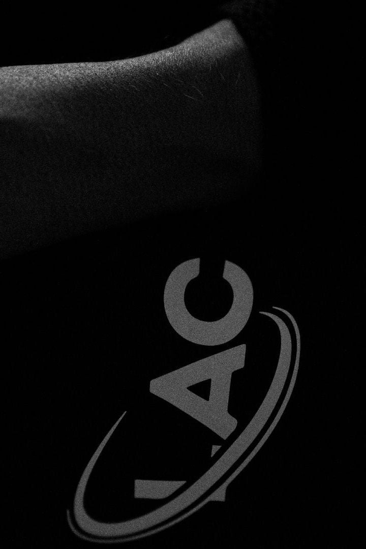 Close-up of a black car seat with 'LAC' logo on a dark background